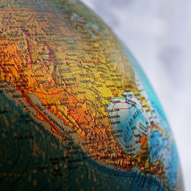A professional headshot of Professor Andrew Briggs against a pale blue backdrop